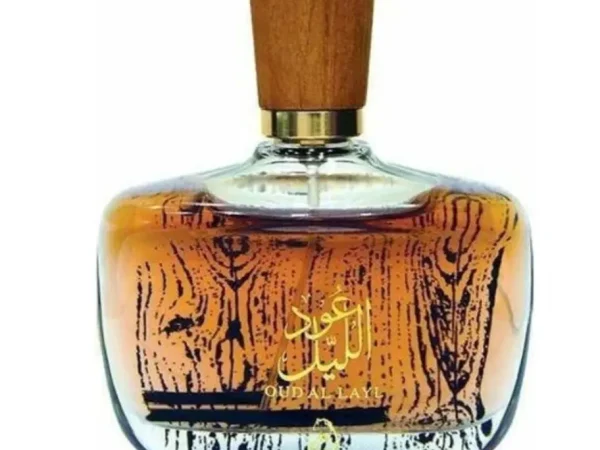 Arabiyat oud al layl perfume bottle beside its box against white